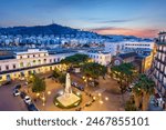 Salerno, Italy cityscape over Piazza Vittorio Veneto and the main station at dawn. (The 1923 War Monument translation: To the fallen of Salerno Province. 1915-1918. 1935,1936, 1940-1945)