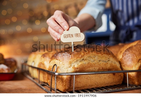 Sales Assistant In Bakery\
Putting Gluten Free Label Into Freshly Baked Baked Sourdough Loaves\
Of Bread