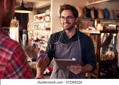 Sales Assistant With Credit Card Reader On Digital Tablet - Shutterstock ID 372396226