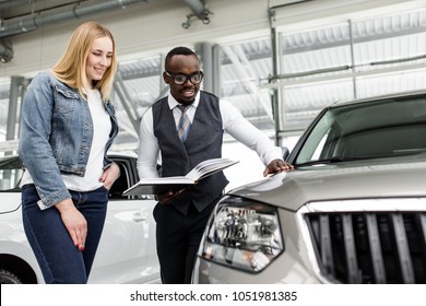 Sales Consultant Shows The Girl A New Car To Buy