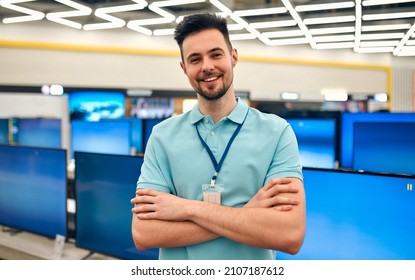 Sales Consultant Stands Cross-handed In Store Of Household Appliances, Electronics And Gadgets. Buying New TV, Sale Day.