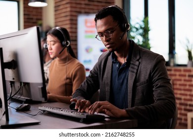 Sales consultant working at call center client care on phone line, using telemarketing equipment. Customer service operator giving support and assistance on helpline telephony network.