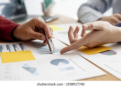 The sales department is having a monthly summary meeting to bring it to the department manager, they are verifying the correctness of the documents that are prepared before bringing in to the manager - Shutterstock ID 1938917740