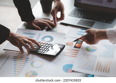 The sales department is having a monthly summary meeting to bring it to the department manager, they are verifying the correctness of the documents that are prepared before bringing in to the manager - Shutterstock ID 2207419833