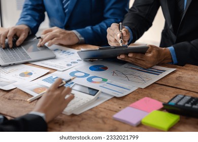 The sales department is having a monthly summary meeting to bring it to the department manager, they are verifying the correctness of the documents that are prepared before bringing in to the manager - Powered by Shutterstock