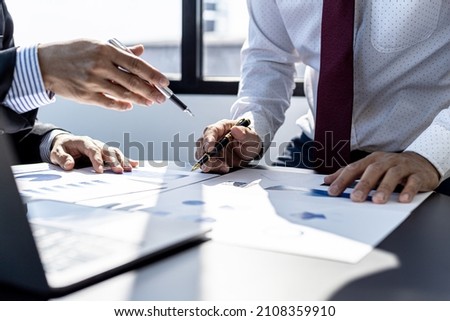 The sales department is having a monthly summary meeting to bring it to the department manager, they are verifying the correctness of the documents that are prepared before bringing in to the manager