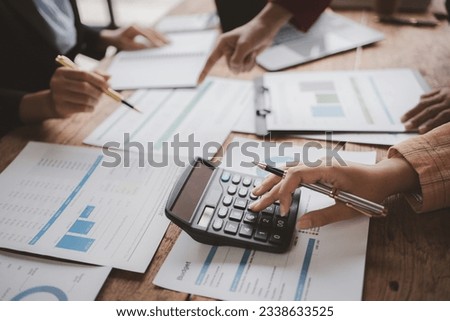 The sales department is having a monthly summary meeting to bring it to the department manager, they are verifying the correctness of the documents that are prepared before bringing in to the manager.