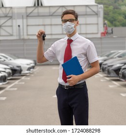 Sales Manager Of A Car Dealership In A Disposable Protective Mask On His Face