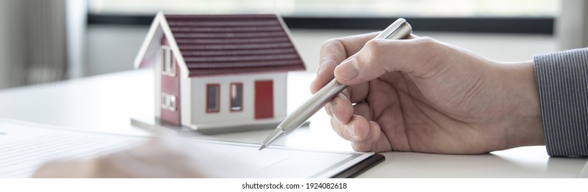 Sales manager or real estate agent will be prepared to show you a sample home and detail the terms of buying a home with insurance promotions, Attention to property services and insurance concept.