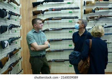 Sales Managers Presented New Sport Rifles Placed On The Counter Of The Gun Shop, Buyers Watching. Arms And Safety 2021. June 15, 2021. Kyiv, Ukraine