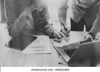 Sales Managers Working Modern Studio.Woman Showing Market Report Charts.Marketing Department Planning New Strategy,using Digital Devices.Researching Process Wood Table.Horizontal.Blurred,black White.