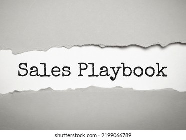 Sales Playbook On Grey Torn Paper. Business Concept