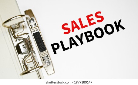 Sales Playbook On A Sheet Of Paper In A Binder. Financial And Business Concept