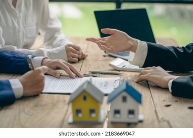 The sales representative offers a home purchase contract to purchase a house or apartment. Or talk about loans and interest rates and insurance, real estate concepts. - Shutterstock ID 2183669047