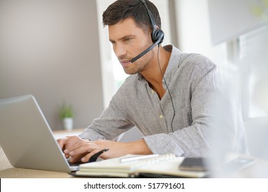 Sales Representative Working From Home On Laptop Computer