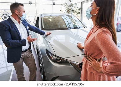 Sales Specialist Demonstrating The Car To His Interested Customer