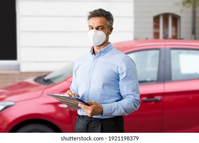 Salesman In Car Salon Or Auto Dealership Wearing Face Mask