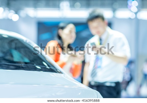 Salesman sell
cars to customers at the auto
show