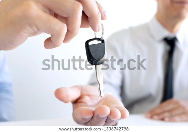 Salesman send key to customer
after good deal agreement, Concept of car insurance, rental,
sales.