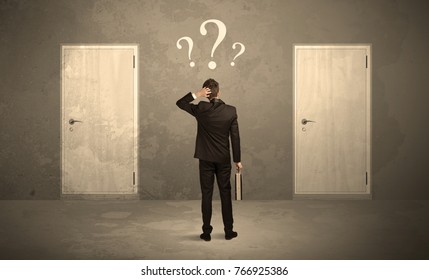 Salesman Standing In Front Of Two Doors, Unable To Make The Right Decision Concept With Question Marks Above His Head