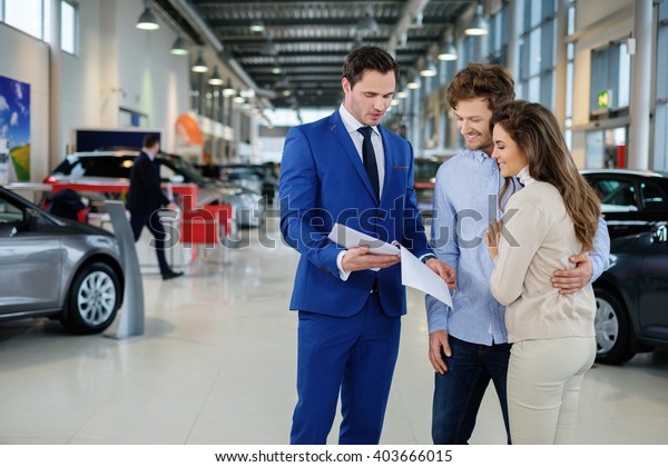 Salesman Talking Young Couple Dealership Showroom Stock Photo (Edit Now ...