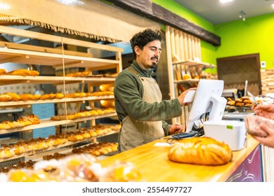Salesman using touchscreen computer to calculate the bill of a client in the counter of bakery shop - Powered by Shutterstock - Get 15% off with code: PIKWIZARD15