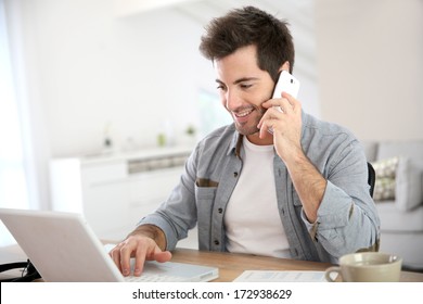 Salesman Working From Home And Talking On Phone