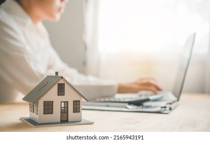 Salesperson Concept Of Holding House Keys, House Keys For A New Home, New Home Purchase. A Loan Agreement For Real Estate, A Loan Deal For Real Estate, A Loan Agreement For Real Estate