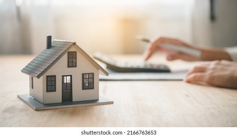 Salesperson Concept Of Holding House Keys, House Keys For A New Home, New Home Purchase. A Loan Agreement For Real Estate, A Loan Deal For Real Estate, A Loan Agreement For Real Estate