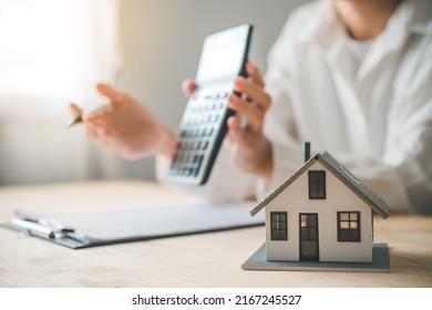 Salesperson Concept Of Holding House Keys, House Keys For A New Home, New Home Purchase. A Loan Agreement For Real Estate, A Loan Deal For Real Estate, A Loan Agreement For Real Estate