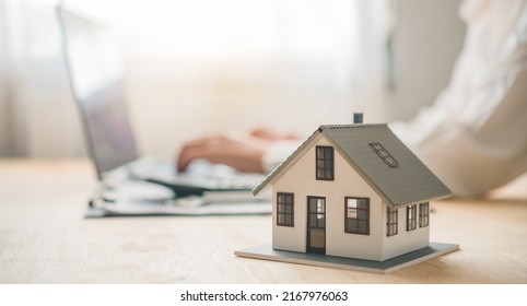 Salesperson Concept Of Holding House Keys, House Keys For A New Home, New Home Purchase. A Loan Agreement For Real Estate, A Loan Deal For Real Estate, A Loan Agreement For Real Estate