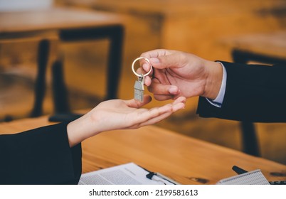 Salesperson Concept Of Holding House Keys, House Keys For A New Home, New Home Purchase. A Loan Agreement For Real Estate, A Loan Deal For Real Estate, A Loan Agreement For Real Estate	

