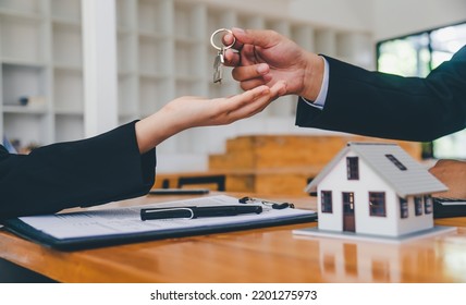 Salesperson Concept Of Holding House Keys, House Keys For A New Home, New Home Purchase. A Loan Agreement For Real Estate, A Loan Deal For Real Estate, A Loan Agreement For Real Estate	

