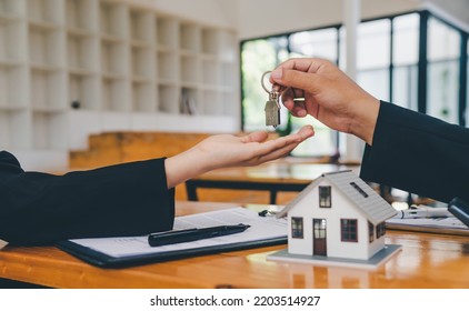 Salesperson Concept Of Holding House Keys, House Keys For A New Home, New Home Purchase. A Loan Agreement For Real Estate, A Loan Deal For Real Estate, A Loan Agreement For Real Estate	

