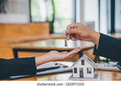 Salesperson Concept Of Holding House Keys, House Keys For A New Home, New Home Purchase. A Loan Agreement For Real Estate, A Loan Deal For Real Estate, A Loan Agreement For Real Estate	

