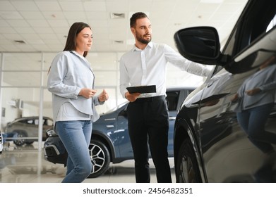 Salesperson selling cars at car dealership. - Powered by Shutterstock