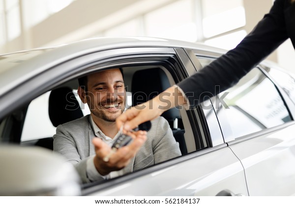 Salesperson selling cars\
at car dealership