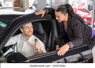 Saleswoman In Car Dealership Selling A Automobile