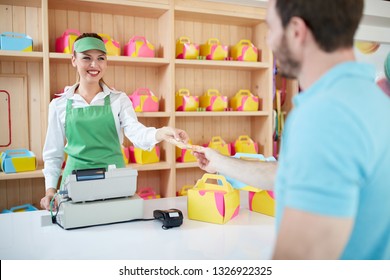 Saleswoman Charges For Sweets In Confectionary Shop