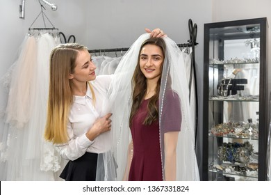Saleswoman Fitting Veil Young Bride ...