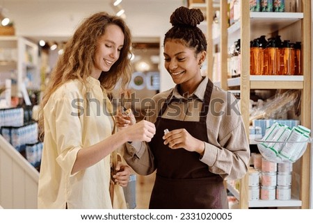 Saleswoman helping customer with purchase