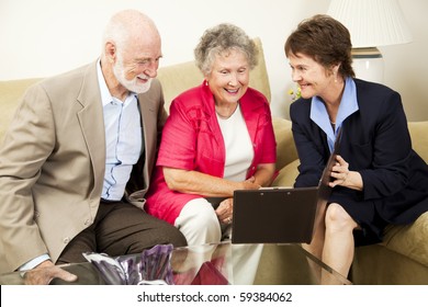 Saleswoman Meets With Senior Couple In Their Home.  Could Be Real Estate, Life Insurance, Etc.