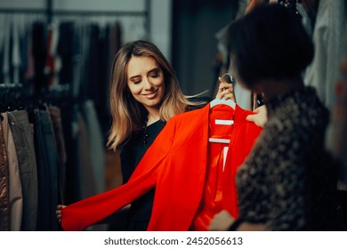 
Saleswoman Presenting a Blazer to her Fashion Store Customer. Happy buyer checking out formal wear in a mall boutique 
 - Powered by Shutterstock