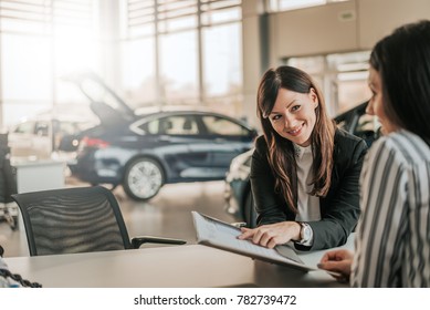 Saleswoman showing contract to customer. - Powered by Shutterstock