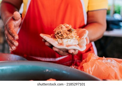 Saleswoman showing traditional raw pupusa. Elaboration of traditional pupusas, elaboration of the dough for traditional pupusas - Shutterstock ID 2185297101