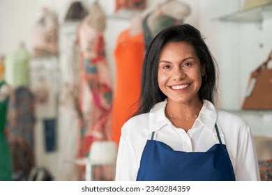 Saleswoman smiles for portrait in clothing store - Powered by Shutterstock