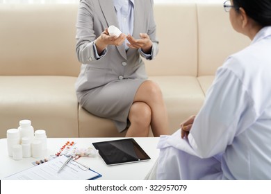 Saleswoman telling about drugs to the medical worker