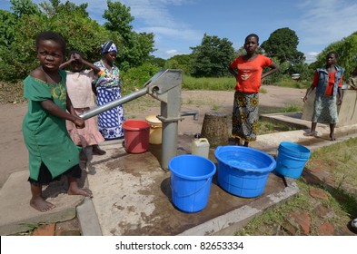 SALIMA, MALAWI-APRIL 10:African unidentified children take water far from their home, in Salima on April 10, 2011.Many children do kilometers on foot and do not attend school to help their family during drought.