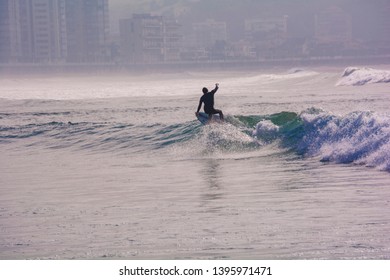 SALINAS, SPAIN - 12 DE MAYO DE 2019: Riding the waves. A talented surfer