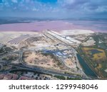 Salinas of Torrevieja. Aerial wide view on rose salty lake and small bungalows and highway to Cartagena